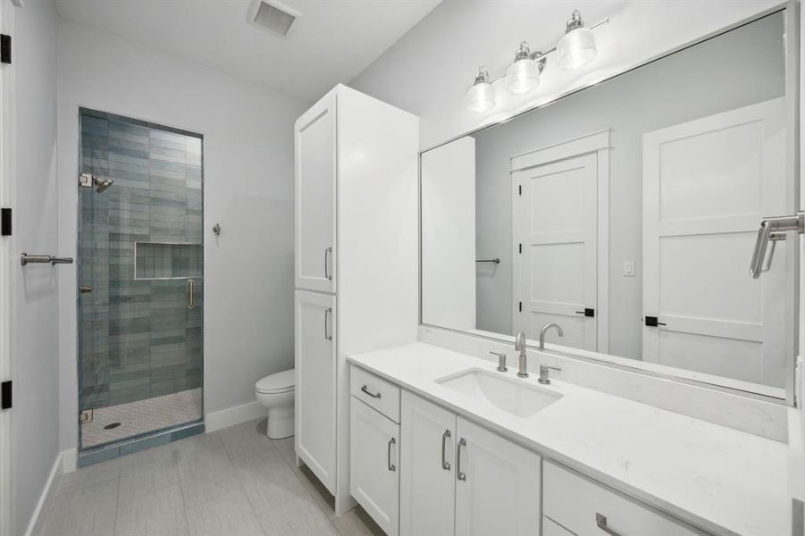 This Bathroom has two Entrances, one from the hall and other from Bedroom, Walk-in Shower and Floor to Ceiling TIle