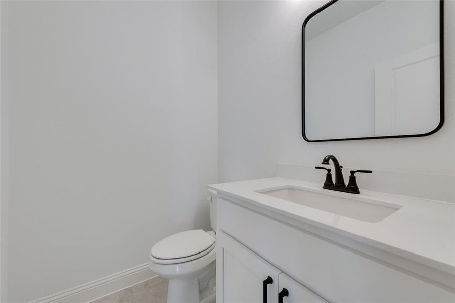 Bathroom featuring tile patterned floors, vanity, and toilet