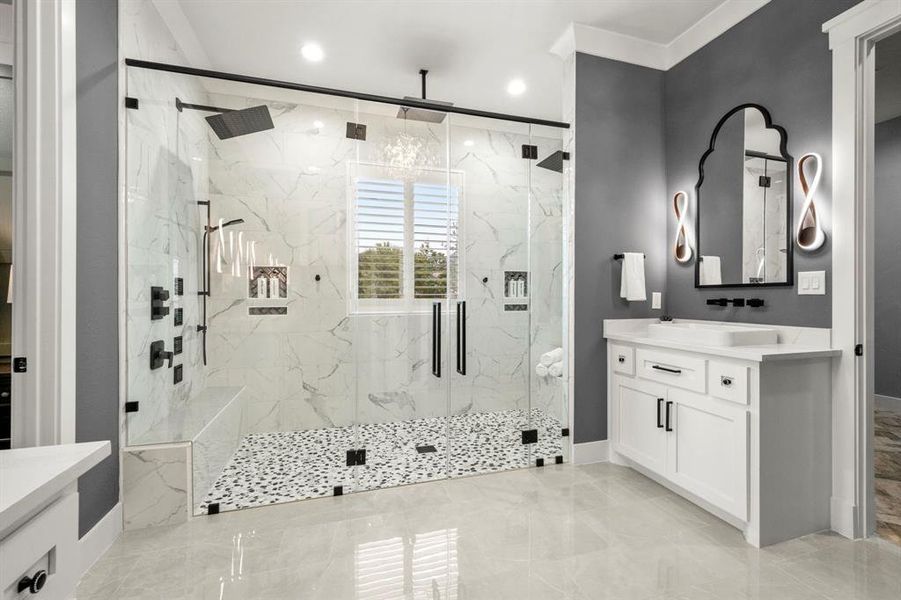 Primary shower for two - two jet systems, handheld shower heads, rain heads, shampoo shelves, and benches - floor to ceiling tile and European glass shower doors.