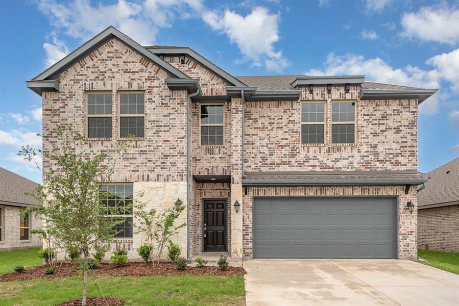 View of front of property featuring a garage