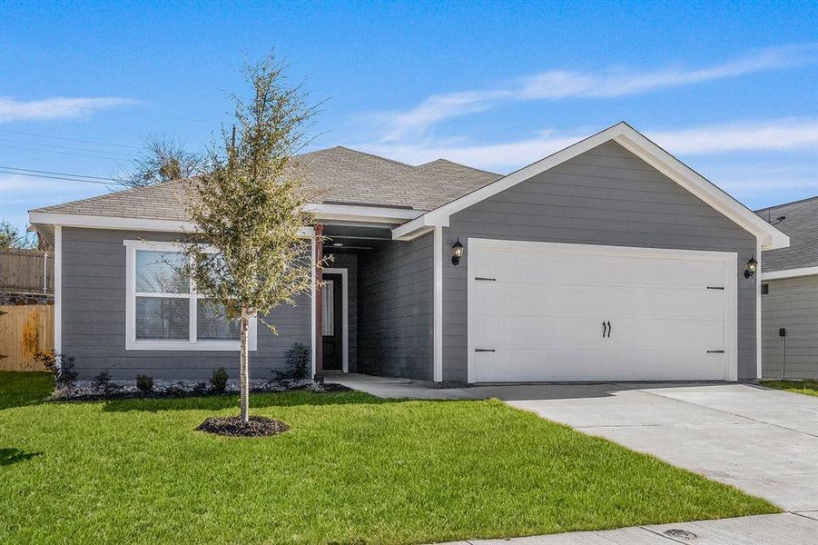 Single story home with a garage and a front lawn