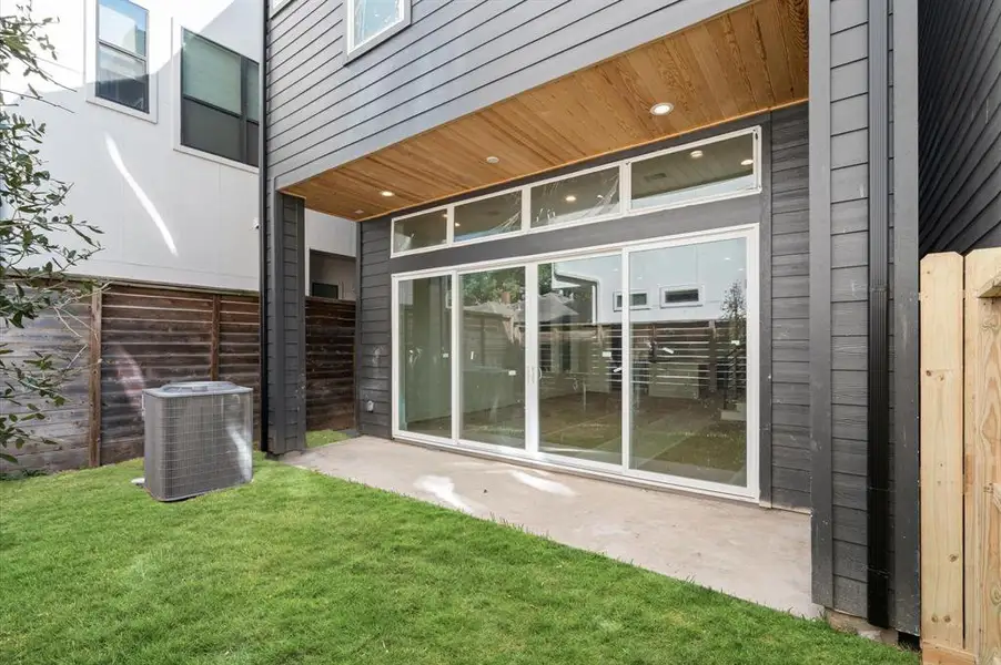 Fabulous bank of windows and sliding glass doors lead to the covered back patio off of first floor living.