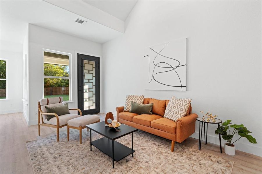 Living room featuring light hardwood / wood-style flooring and vaulted ceiling