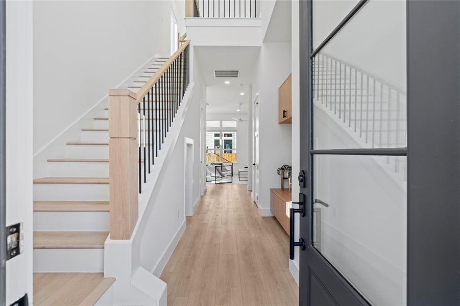 The 22-foot entry makes a bold statement, opening into a warm, inviting living area featuring Vecino’s hallmark Roman Clay accent wall and a striking fireplace.