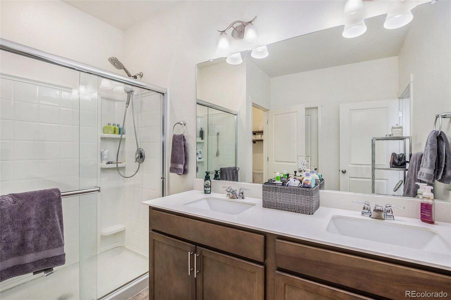 Primary ensuite with double sinks and large walk-in closet.