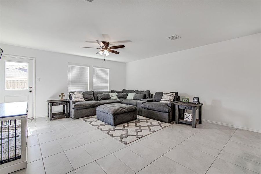 Tiled living room featuring ceiling fan