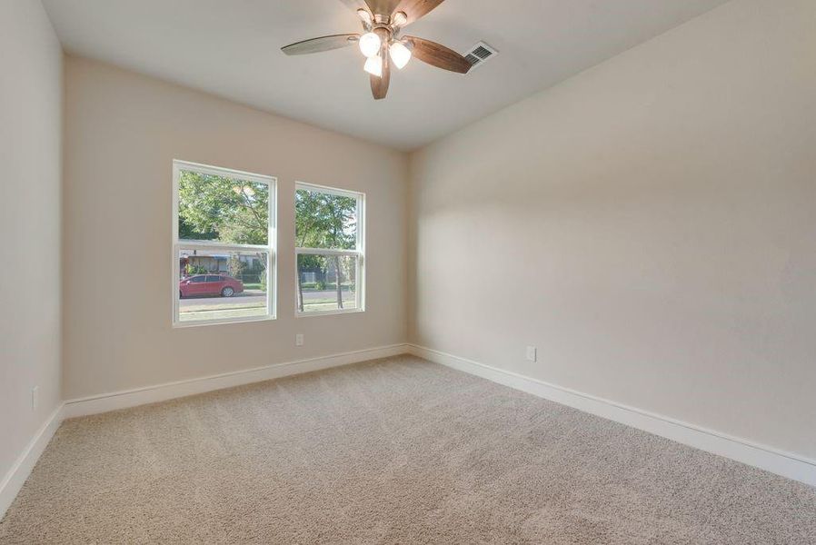 Spare room with ceiling fan and carpet flooring