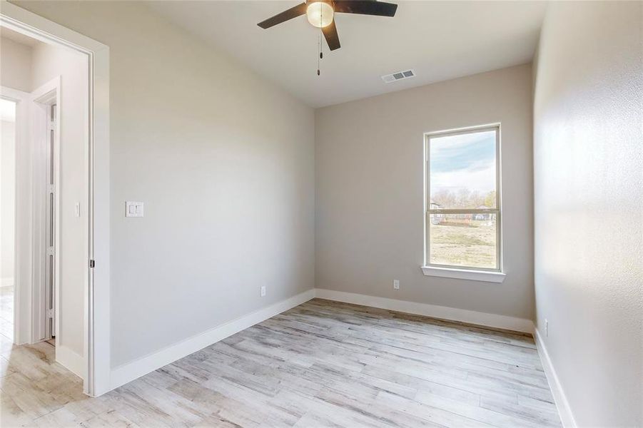 Unfurnished room featuring light hardwood / wood-style flooring and ceiling fan