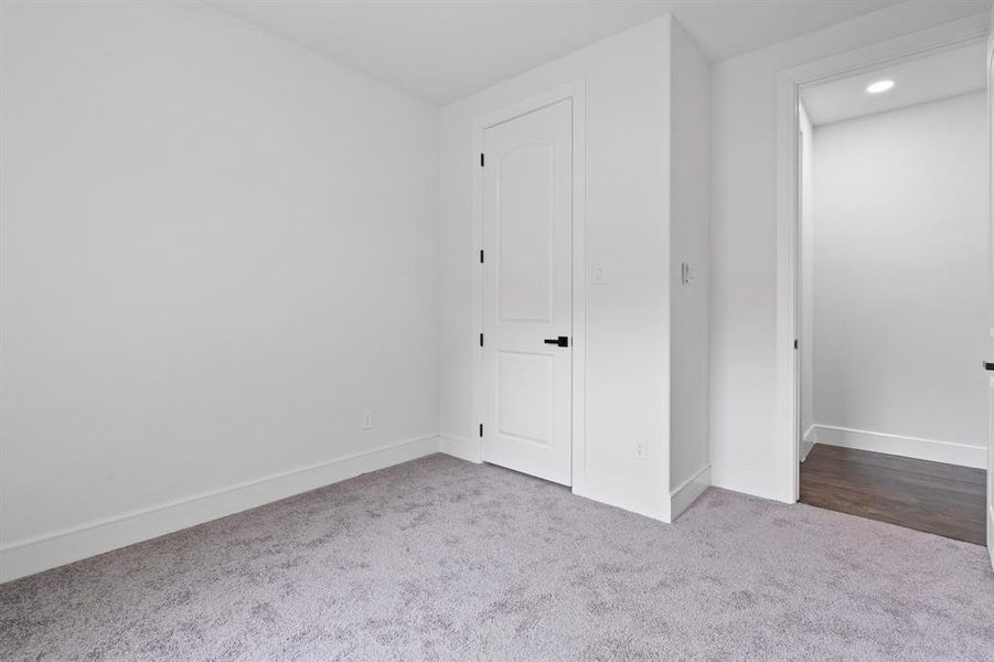 Unfurnished bedroom featuring hardwood / wood-style floors