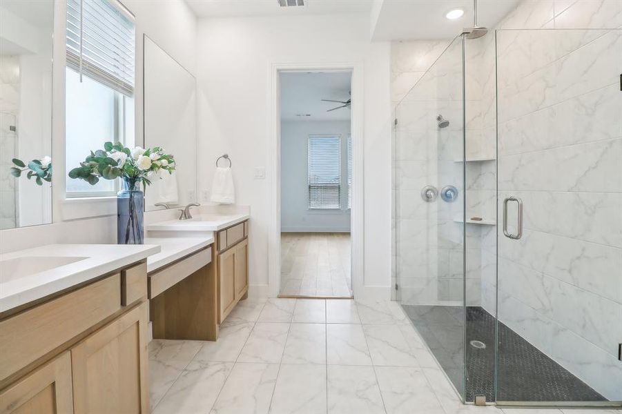 Bathroom featuring tile floors, a shower with door, ceiling fan, and dual bowl vanity