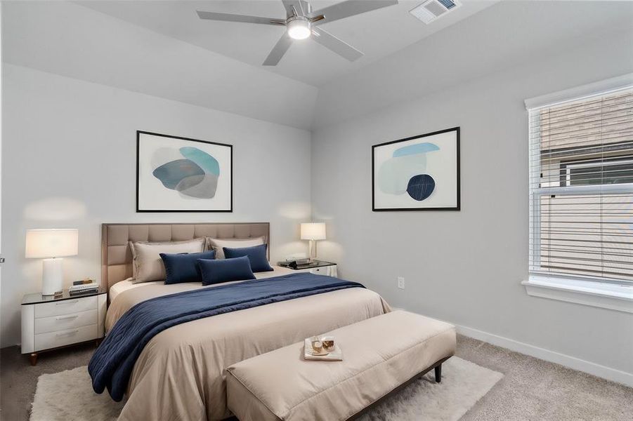 Secondary bedroom features plush carpet, custom paint, ceiling fan, and a large window with privacy blinds.