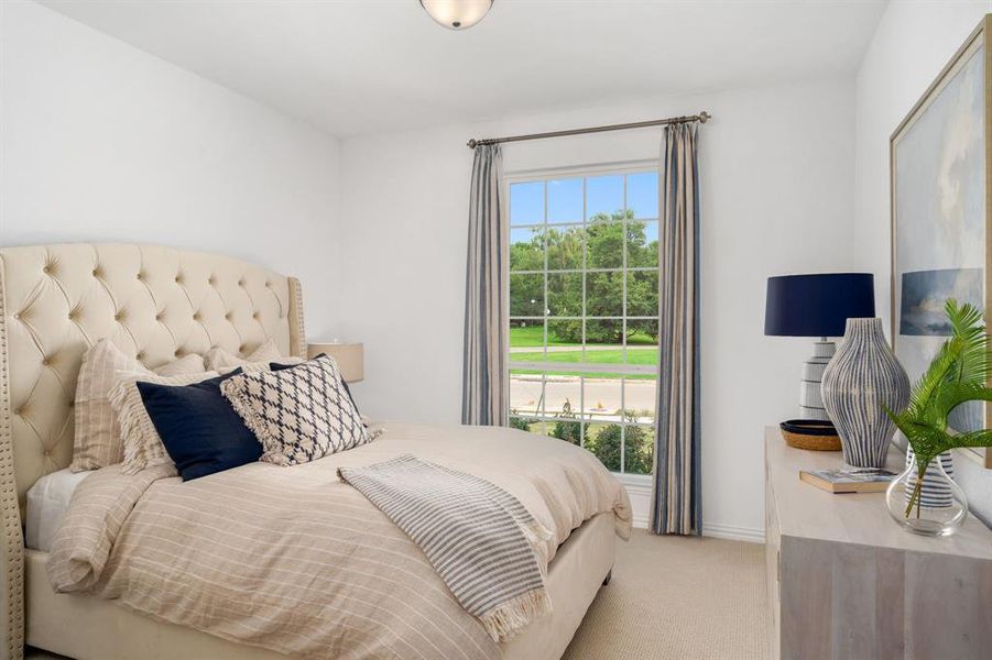 Bedroom with light colored carpet