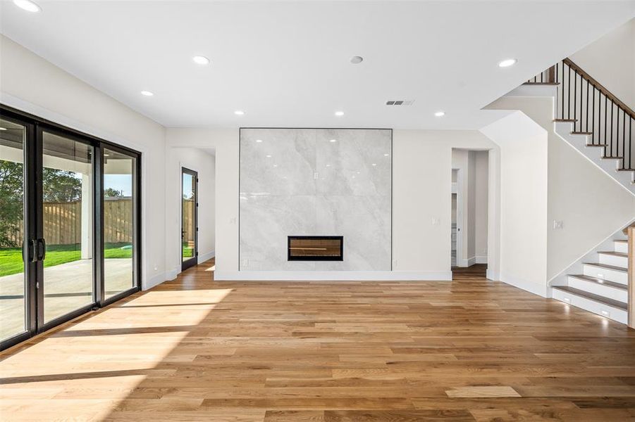 Unfurnished living room featuring a fireplace and light hardwood / wood-style flooring