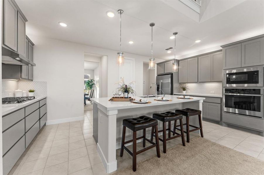 A convenient dry bar completes the space, making it perfect for both cooking and entertaining guests in style.