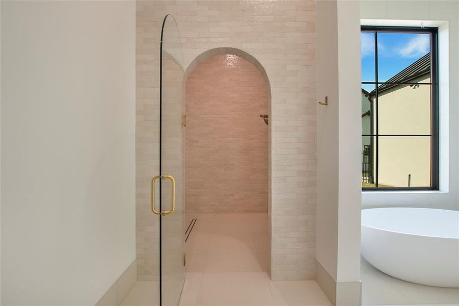 Bathroom featuring tile patterned flooring, shower with separate bathtub, and a wealth of natural light