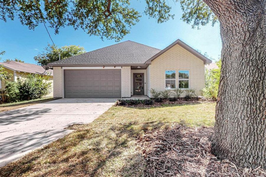 Ranch-style house with a front yard and a garage