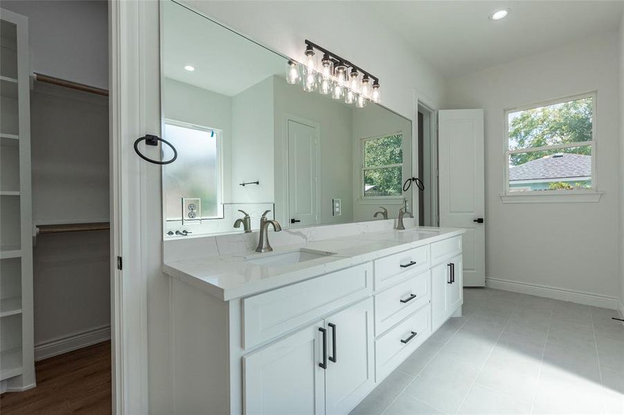 Walk-in closet that wraps behind the mirror and sinks