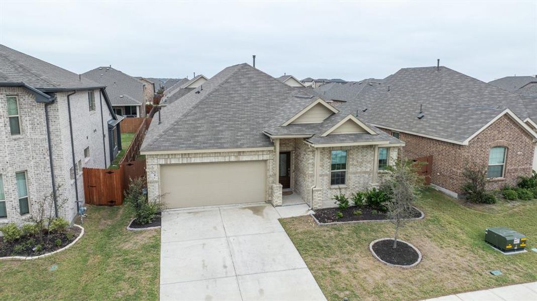 View of front of property featuring a front lawn and a garage