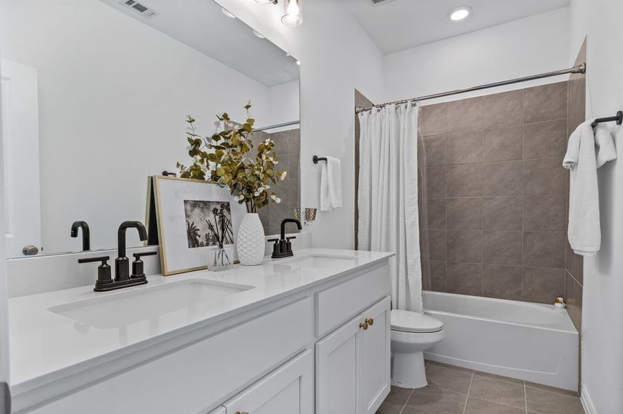 Full bathroom with vanity, tile patterned flooring, toilet, and shower / bathtub combination with curtain