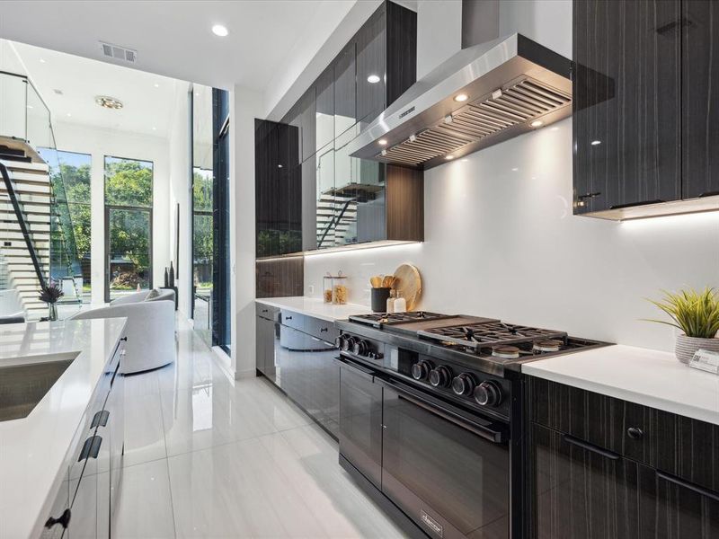 Kitchen featuring a luxury gas range and double ovens