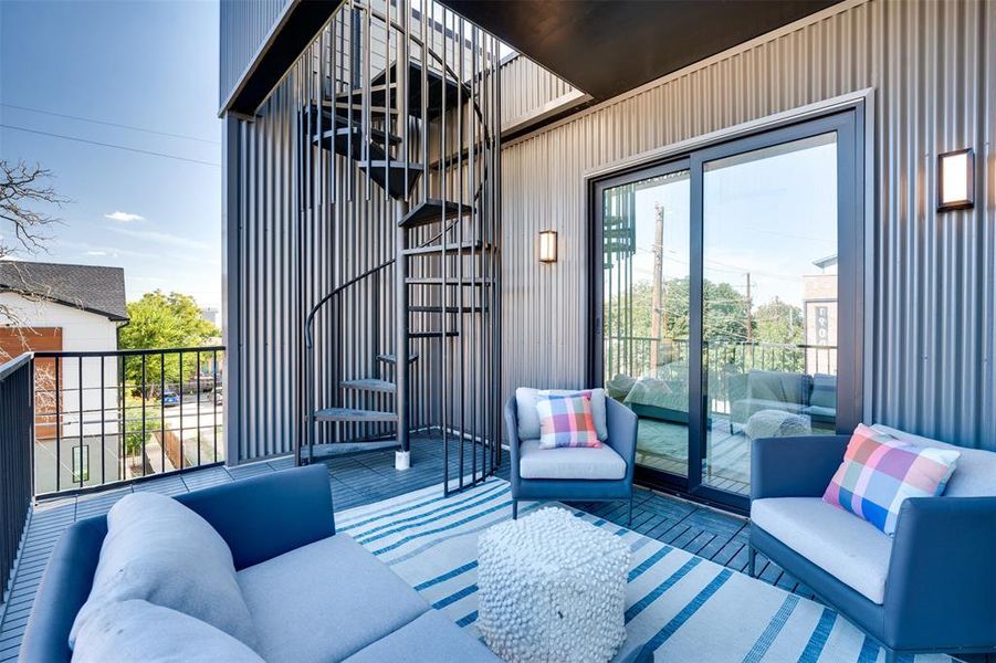 View of patio featuring a balcony and an outdoor living space