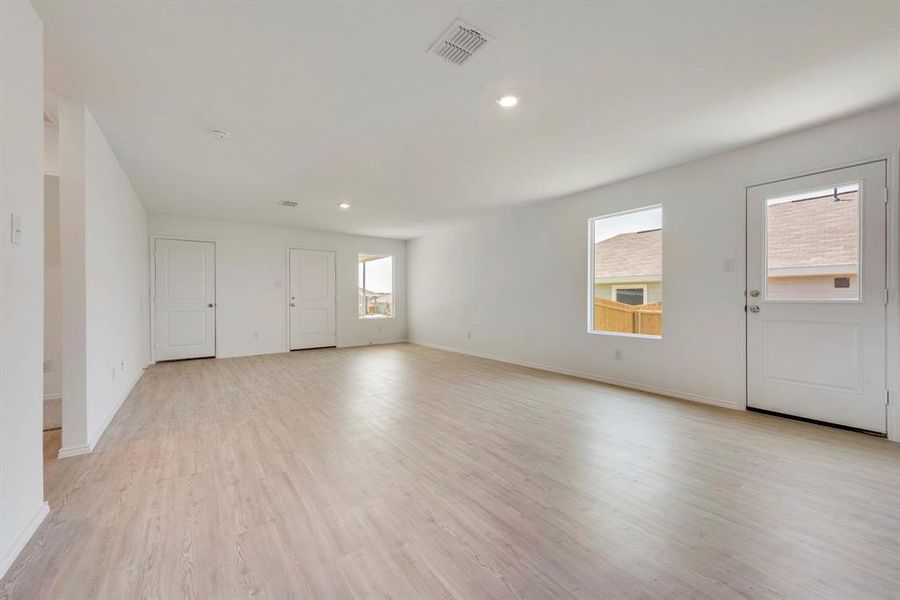 Empty room featuring light hardwood / wood-style floors and a wealth of natural light