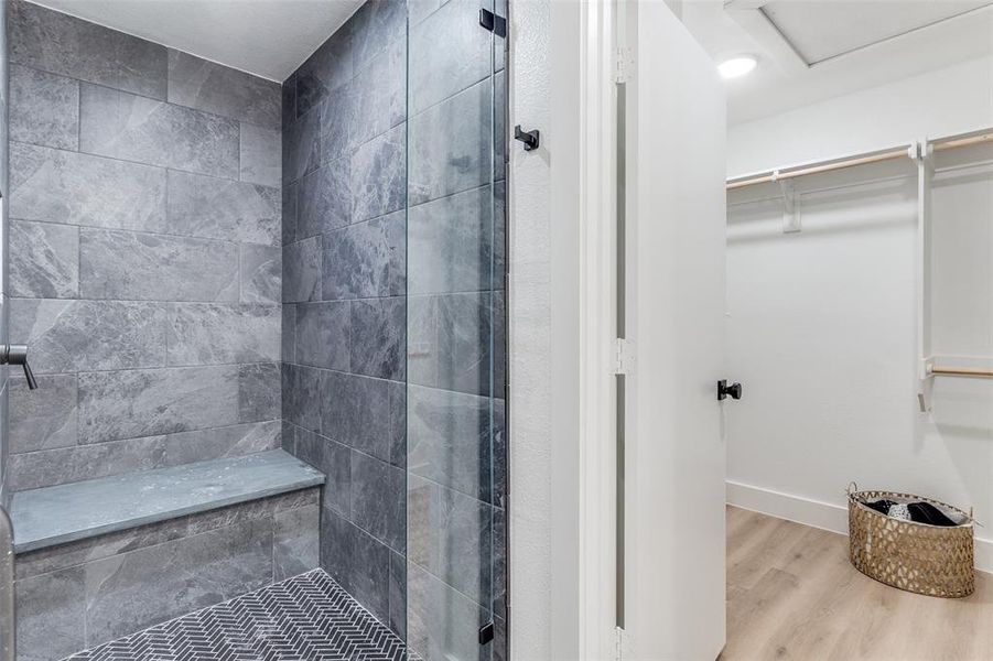 Bathroom featuring a tile shower and hardwood / wood-style floors