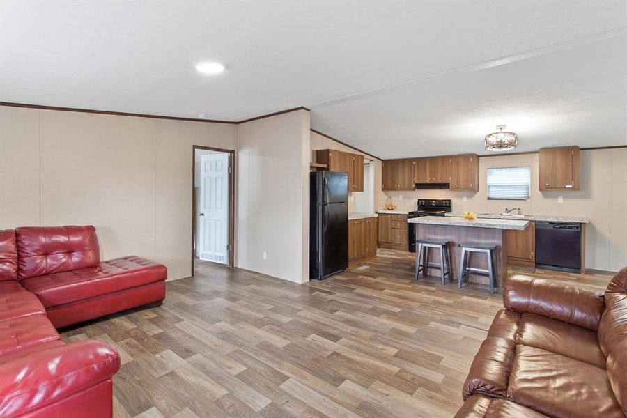 This inviting area effortlessly transitions into the kitchen, making it perfect for both entertaining and everyday living.