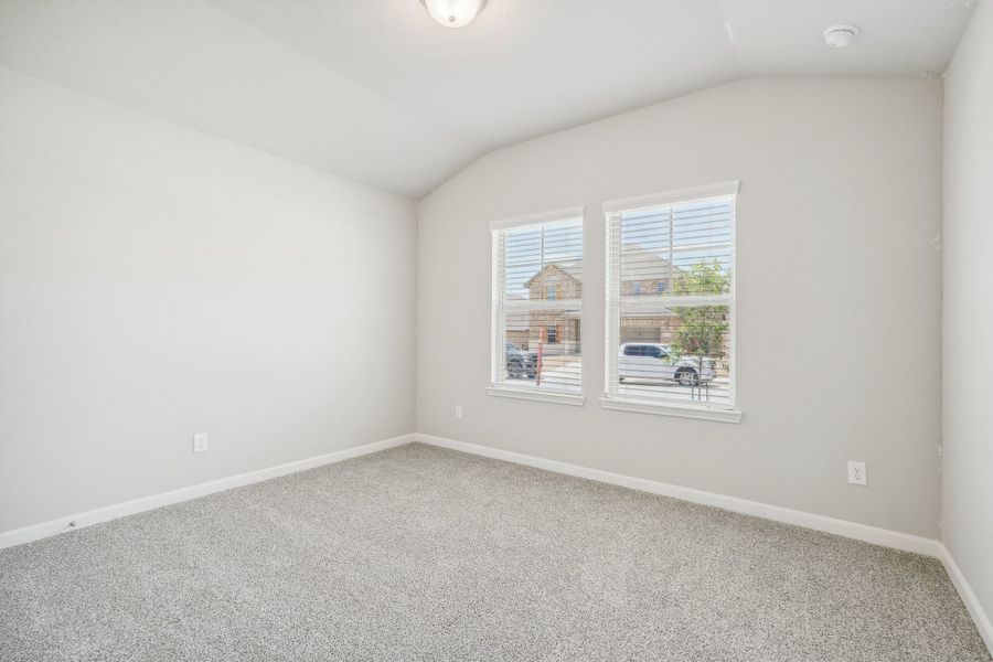 Guest bedroom in the Fitzhugh floorplan at a Meritage homes community.