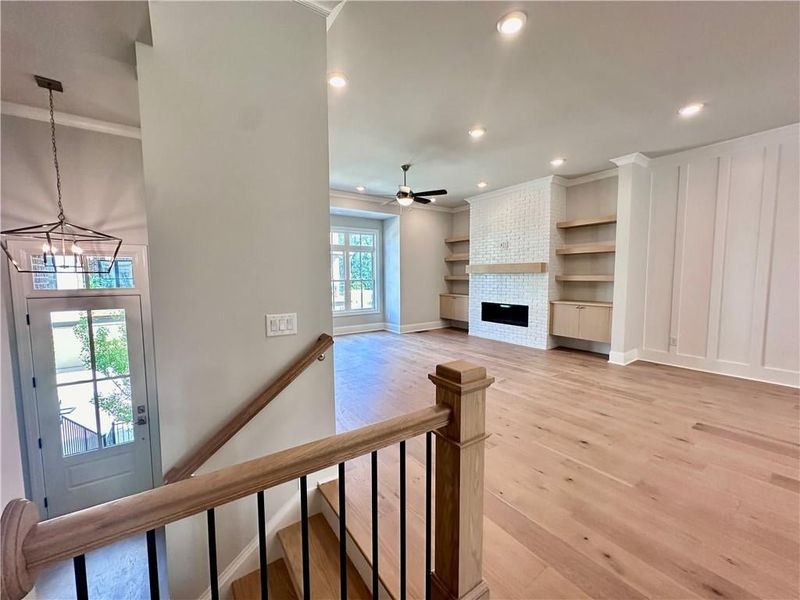 Living room is situated in the front of home, outed with floating cabinets and shelving