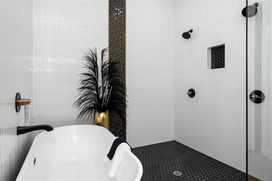 Bathroom featuring independent shower and bath and tile walls