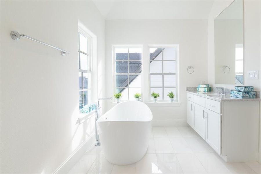 Primary bath with high ceilings and furniture grade cabinets.  (similar home and features)