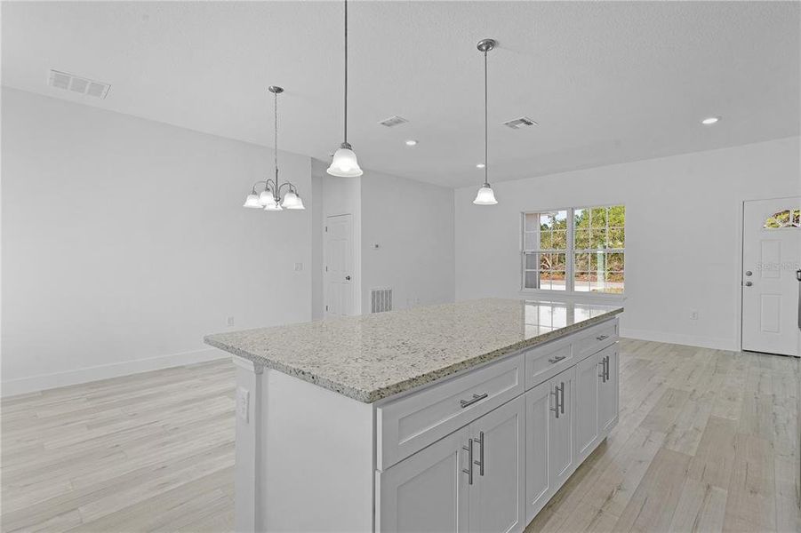 From the kitchen, looking across the island into dining area on the left and living area