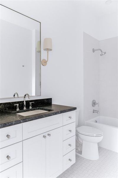 Full bathroom featuring vanity, toilet, and shower / bathtub combination