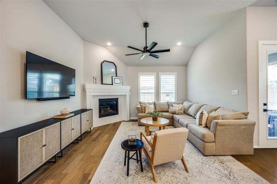 Living room with a fireplace and ceiling fan