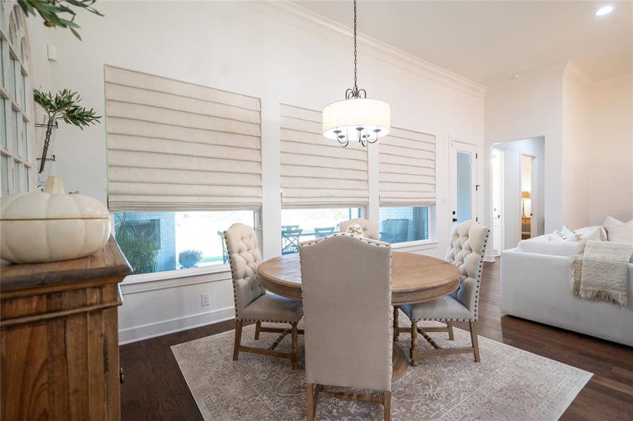 Dining area featuring crown molding and dark hardwood / wood-style floors