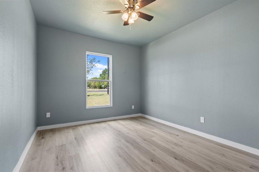 Spare room featuring ceiling fan and light hardwood / wood-style floors