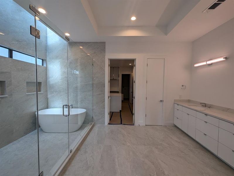 Large master bath with wet room and double sinks.