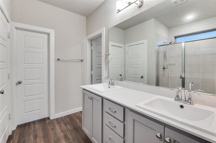 Bathroom featuring dual vanity and hardwood / wood-style floors