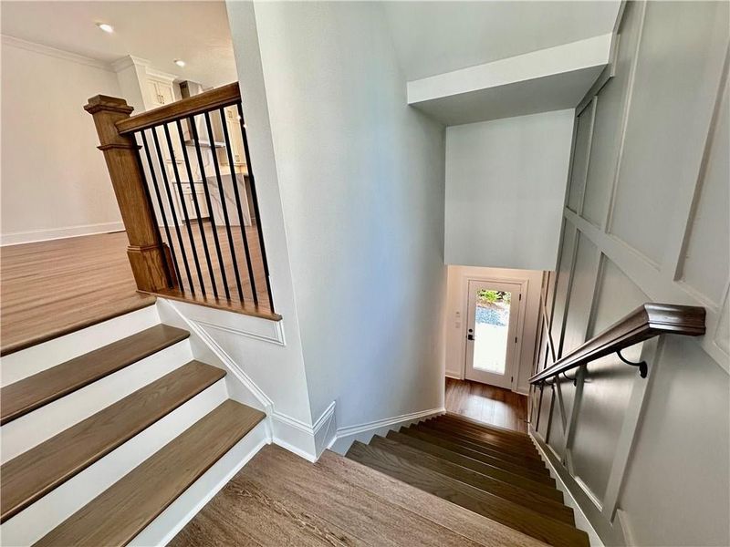 Wraps staircases lead you back down to the terrace level showcasing fourth bedroom with backyard access