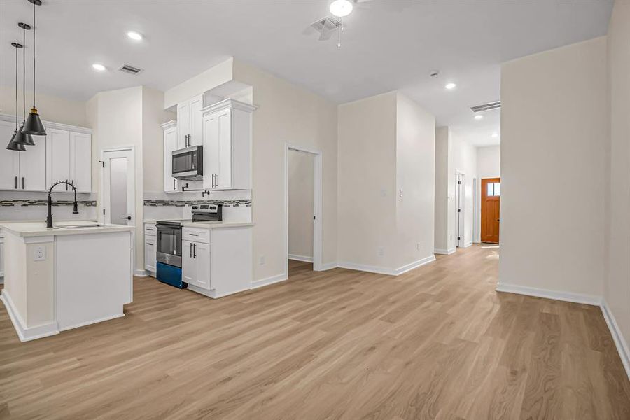 Durable laminate flooring throughout the home for easy maintenance.