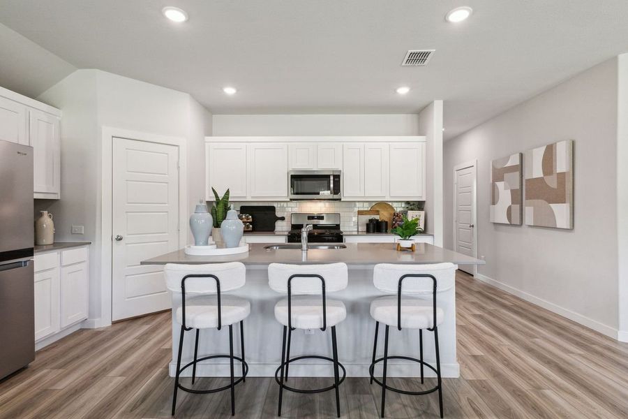 Kitchen in the Emmy II home plan by Trophy Signature Homes - REPRESENTATIVE PHOTO