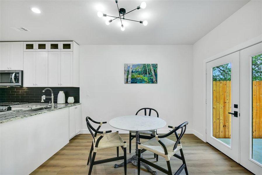 Dining space with light fixture, light wood-type flooring