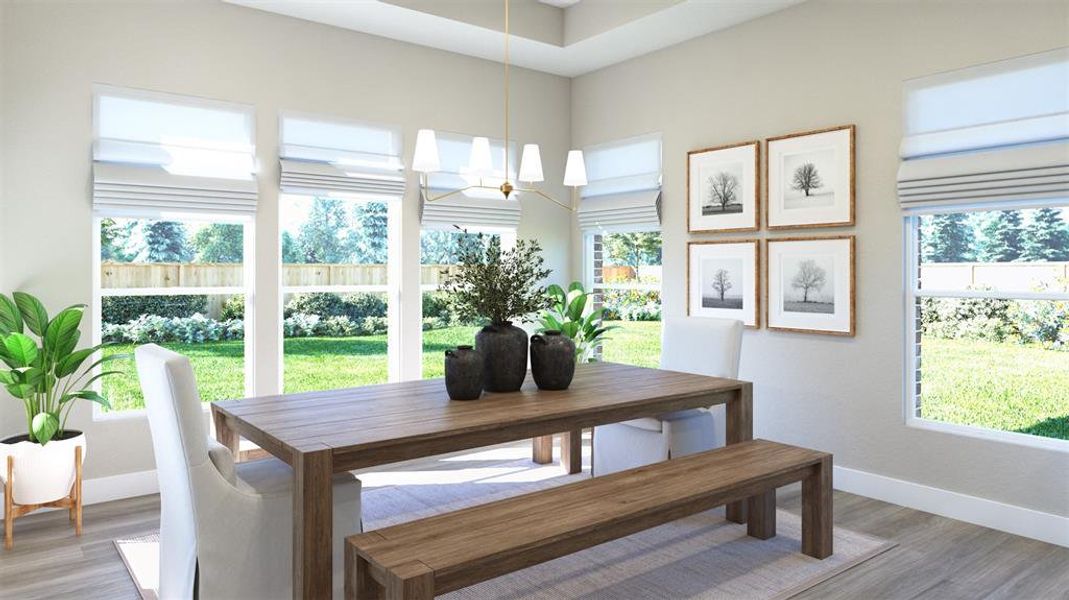 Dining area featuring a wealth of natural light, hardwood / wood-style flooring, and an inviting chandelier