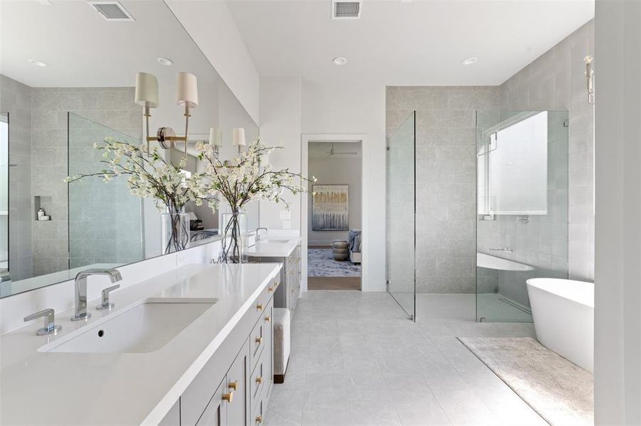 The primary bath features quartz counters, a separate soaking tup, a frameless shower, and dual vanity.