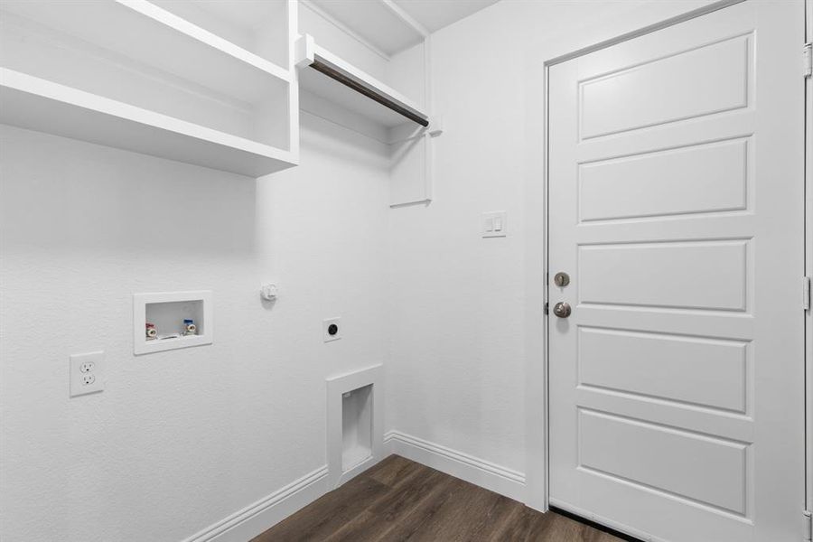 Clothes washing area with hookup for a washing machine, electric dryer hookup, dark hardwood / wood-style floors, and gas dryer hookup