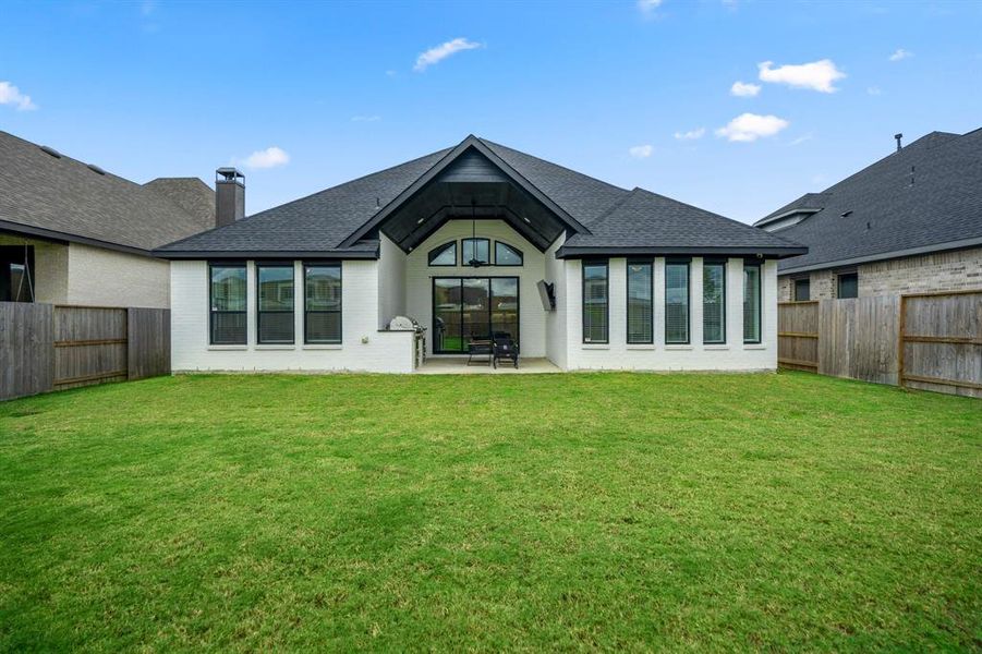 The back of the home includes lots of windows letting in natural light and a perfect view of the private backyard.