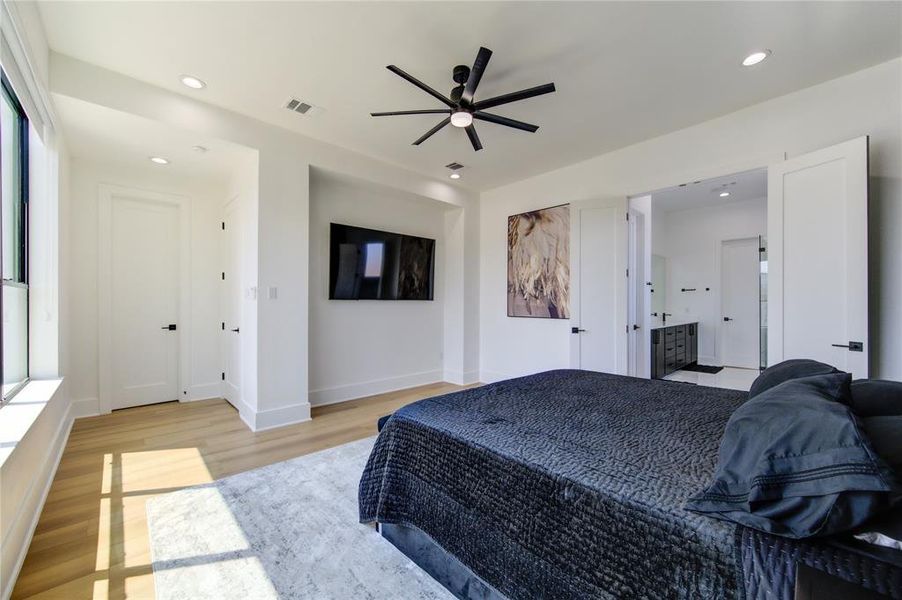 This primary bedroom has 2 custom built-in walk-in closets