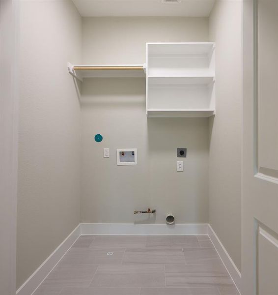 Large utility room with built in shelving.