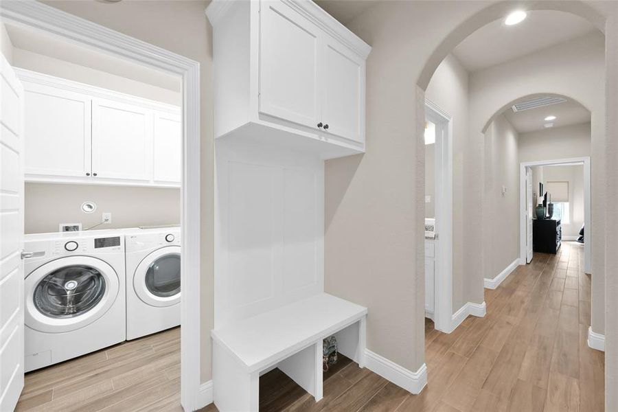 in house laundry room with space for another appliance and mudroom located at garage entry